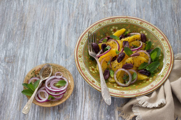 Plate with moroccan salad from oranges on a wooden table