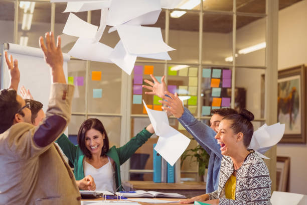 istock Celebrating business people throwing papers in the air 813207598