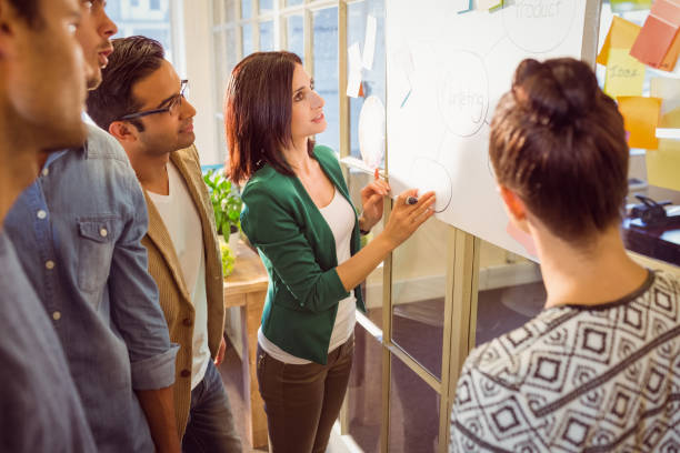 istock Young colleagues in discussion at office 813208154