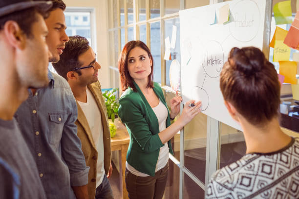 istock Young colleagues in discussion at office 813208286