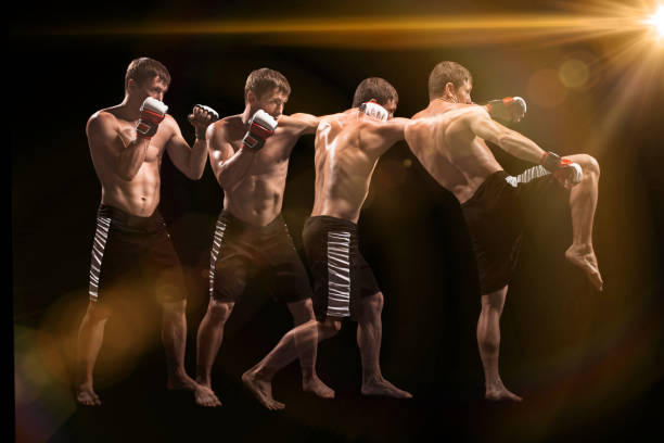 istock Male boxer boxing in punching bag with dramatic edgy lighting in a dark studio 813210820