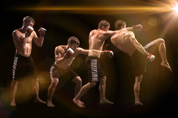 istock Male boxer boxing in punching bag with dramatic edgy lighting in a dark studio 813210886