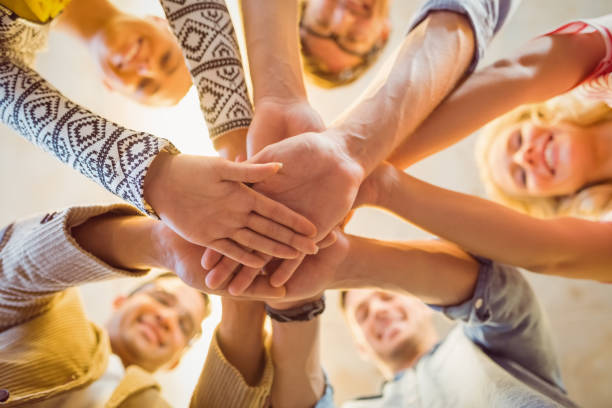 istock Happy business team joining their hands 813218060