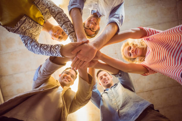 istock Happy business team joining their hands 813220130