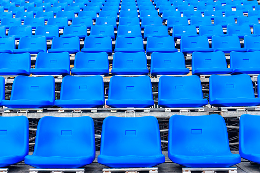 Rows of plastic seating in a stadium at a community baseball field