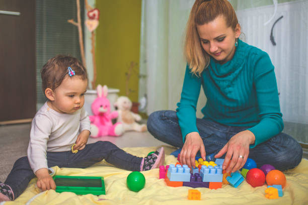 istock Mother and daughter playing on the floor 813225446