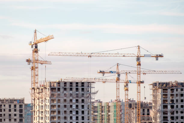 istock Building crane and buildings under construction against evening sky 813226048