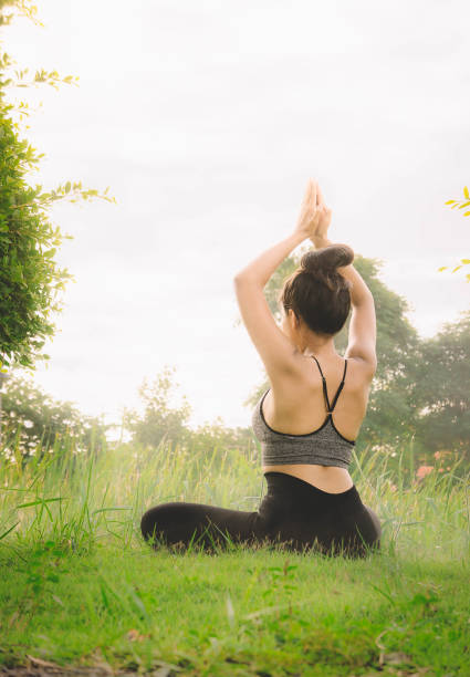 istock woman practicing  yoga day relax in nature 813228926