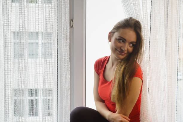 istock Happy woman sitting on windowsill, energizing morning 813236534