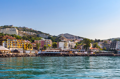 Apartment buildings on seashore in balchik city on black sea coast in Bulgaria at sunny summer day.