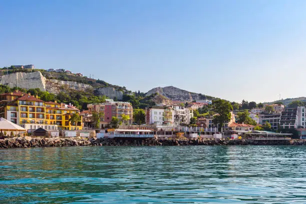 Photo of Apartment buildings on seashore in balchik city on black sea coast in Bulgaria at sunny summer day