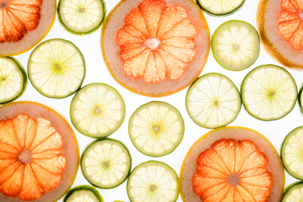 istock Bright lime and grapefruit slices. Juicy transparent fruit on white 813237508