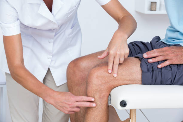 istock Doctor examining her patient knee 813239038