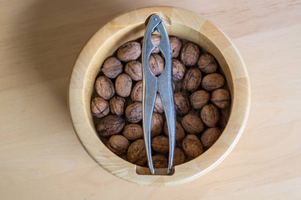 Mixed nuts including walnuts,pecans,almonds and hazelnuts with nutcracker.