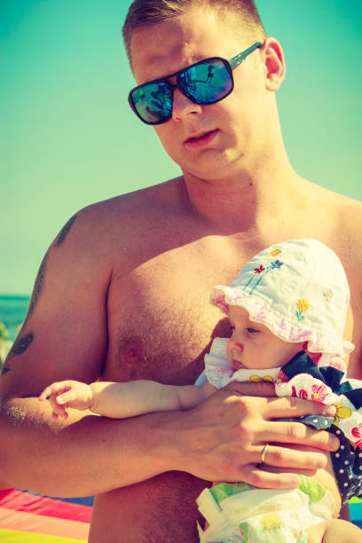 istock Man posing with baby on summer 813239468