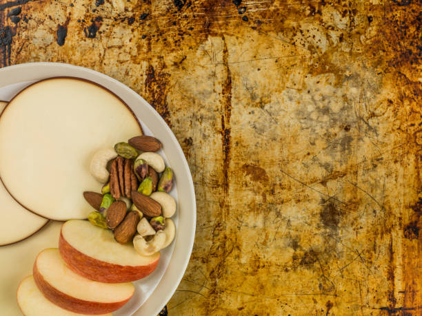 istock Apple and Gouda Cheese Rounds With A Handful of Mixed Nuts 813239620