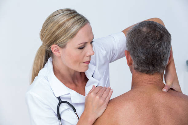 istock Doctor examining her patient shoulder 813242178