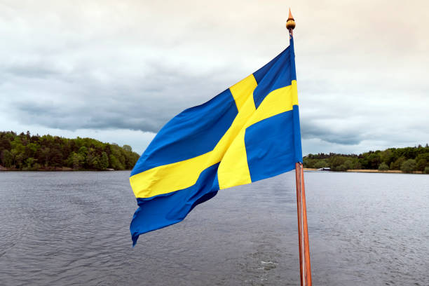 Sailing on Lake Malaren,Stockholm,Sweden Swedish flag on the ship's bow. lake malaren photos stock pictures, royalty-free photos & images