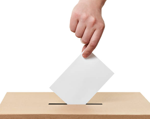 ballot box casting vote election close up of  a ballot box and casting vote on white background voting ballot box voting ballot polling place stock pictures, royalty-free photos & images