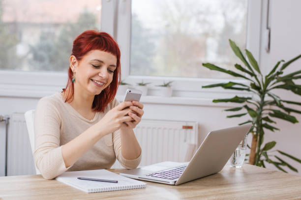 istock Young woman reading messages on the phone 813246464