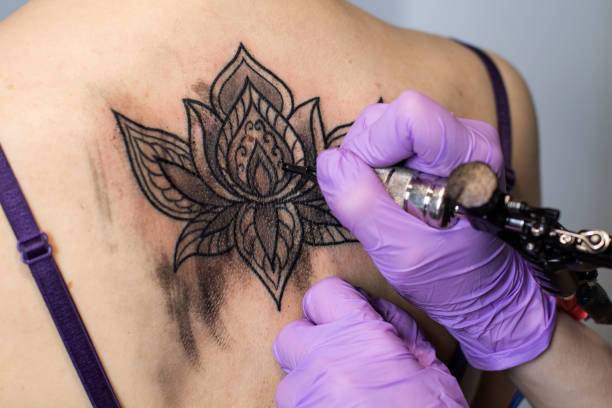 istock tattoo flower on the woman's back 813246964