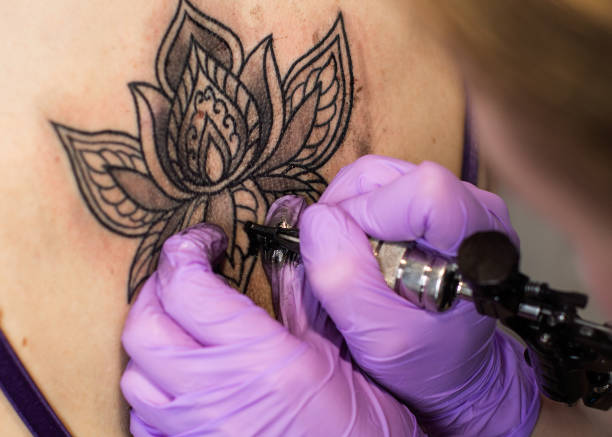 istock tattoo flower on the woman's back 813246970