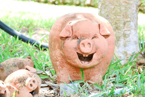 istock Pig dolls statue in green park. 813253782