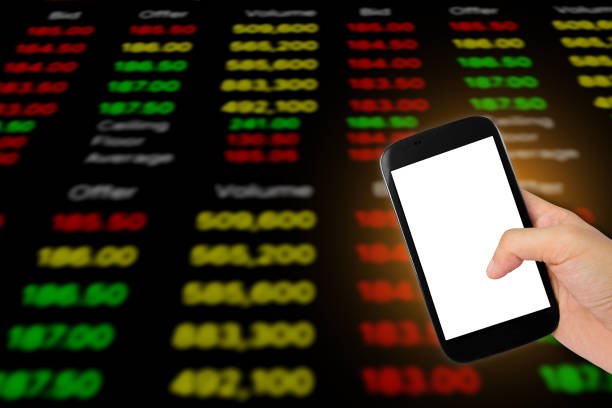 istock cellphone on stock chart market background. 813254346