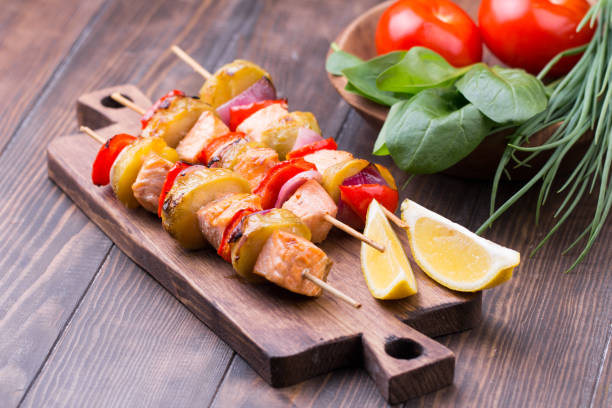 istock Grilled salmon and vegetables on skewers. 813257562