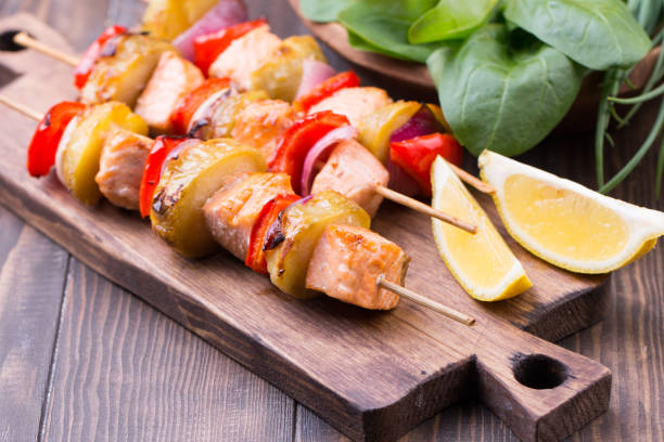 istock Grilled salmon and vegetables on skewers. 813257570
