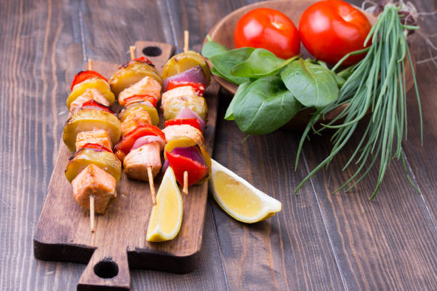 istock Grilled salmon and vegetables on skewers. 813257592