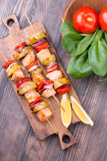 Grilled salmon and vegetables on skewers.