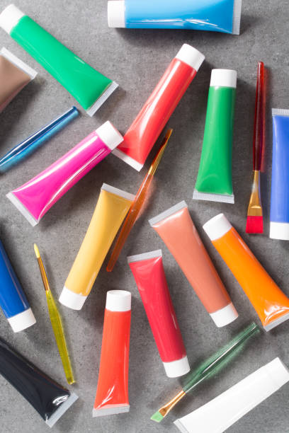 istock Multicolored acrylic paints tubes set with five colorful brushes 813258392
