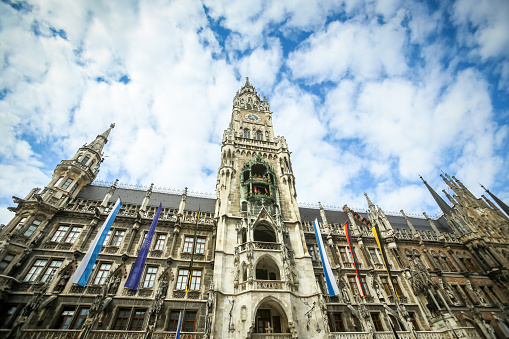Munich, Germany - May 9, 2017 : A low angle view of the New Town Hall with cloudscape at Marienplatz in Munich, Germany.