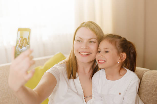 istock Beautiful mother and yound daughter making a selfie. 813291370
