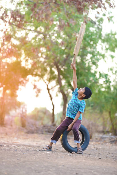 istock Rural Indian Child Playing Cricket 813291664