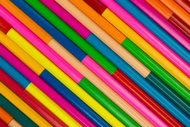 Collection of coloured pencils in a diagonal line pattern as background picture