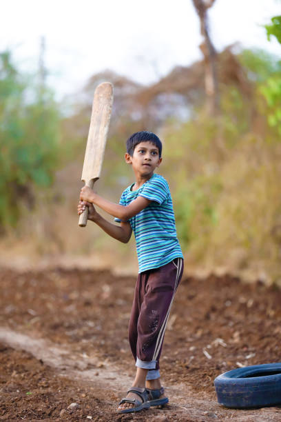istock Rural Indian Child Playing Cricket 813300794
