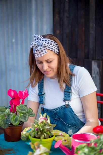 istock Young woman gardening 813300938