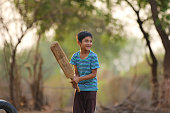 istock Rural Indian Child Playing Cricket 813303650