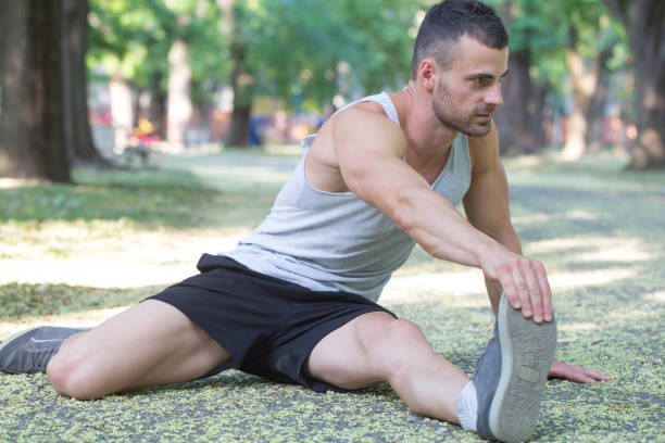 istock Young athlete doing stretching exercises in the park 813303856