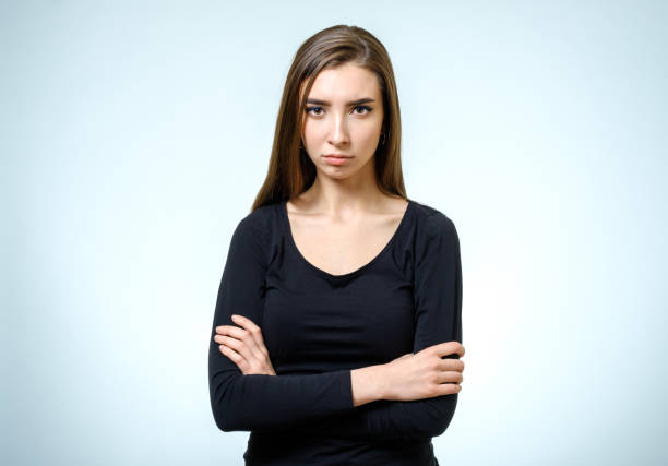 istock Beautiful young confident woman with serious expression isolated on gray 813311672