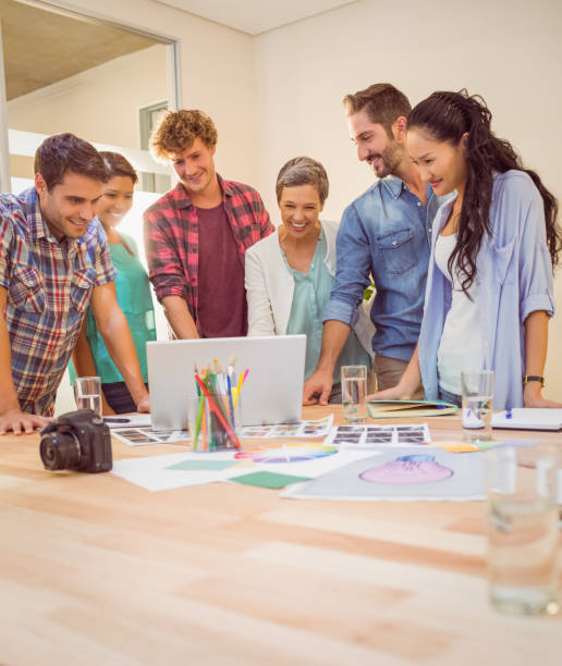 istock Happy creative business team using laptop in meeting 813319944