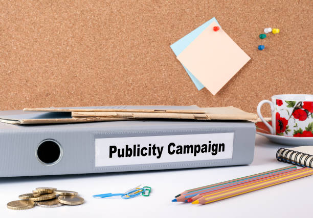 istock Publicity Campaign. Folder on office desk. Money, Coffee Mug and colored pencils 813320122