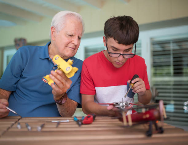 istock Grandfather and kid playing with vintage planes 813325658
