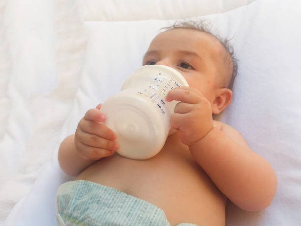 istock three months old baby boy drinking milk from the bottle 813326204