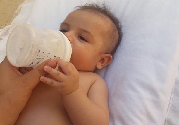 istock three months old baby boy drinking milk from the bottle 813326548
