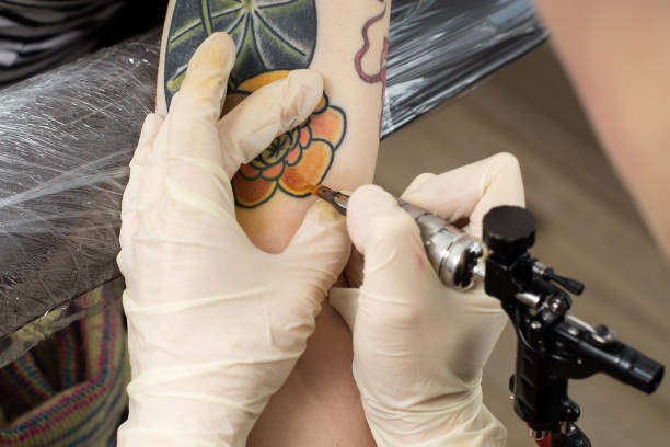 istock master's hands drawing tatto by machine 813343374