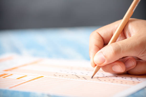 Hand on pencil choosing the test list on the examination
