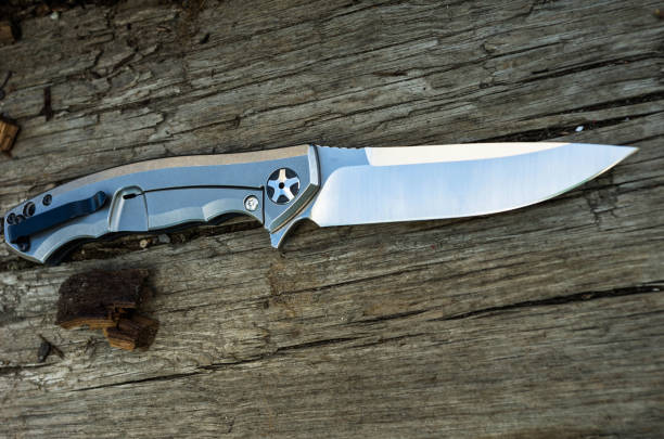 istock Knife with a titanium handle photographed at an angle. 813362692